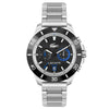 The Lacoste Toronga Dual Time Black Dial Silver Bracelet Watch by Lacoste is a silver wristwatch featuring a black dial with blue accents and a metal bracelet. It includes a dual-time function and displays the iconic Lacoste branding.