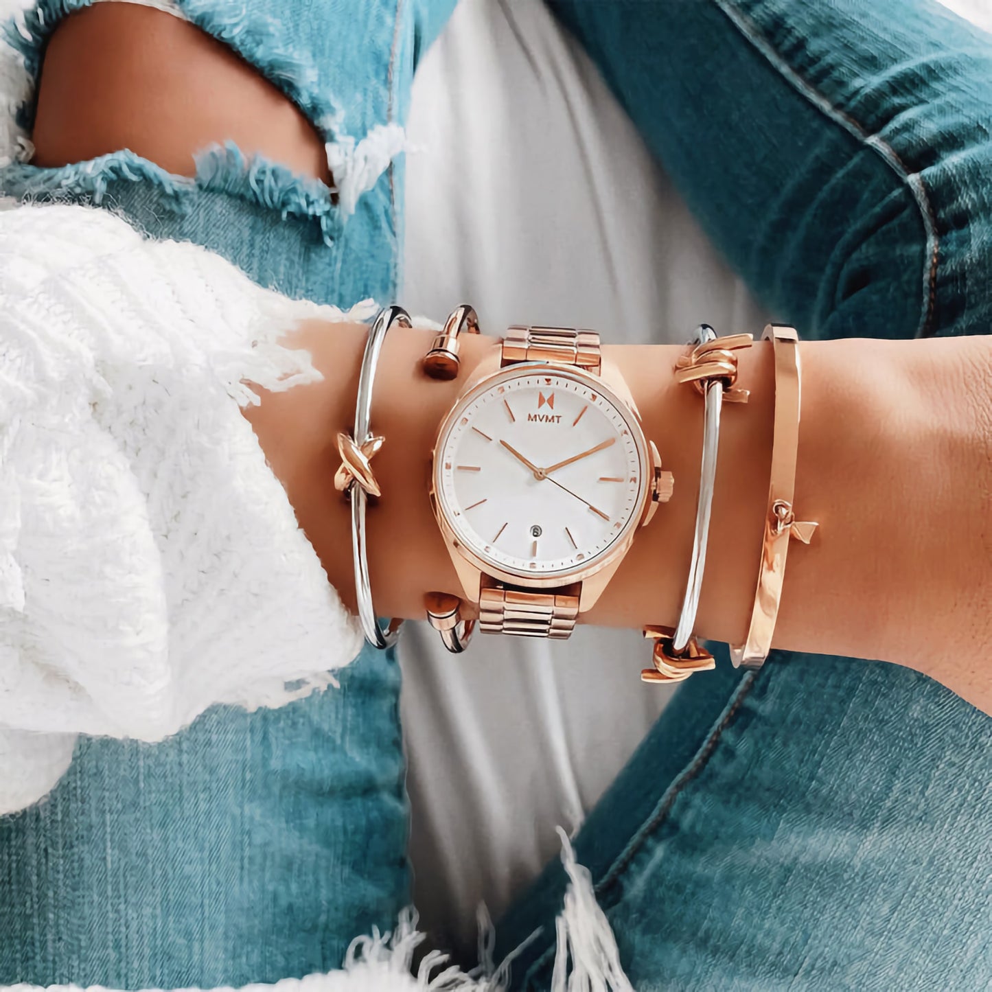 The MVMT Coronada Aurora gold watch pairs perfectly with a white sweater and ripped jeans.