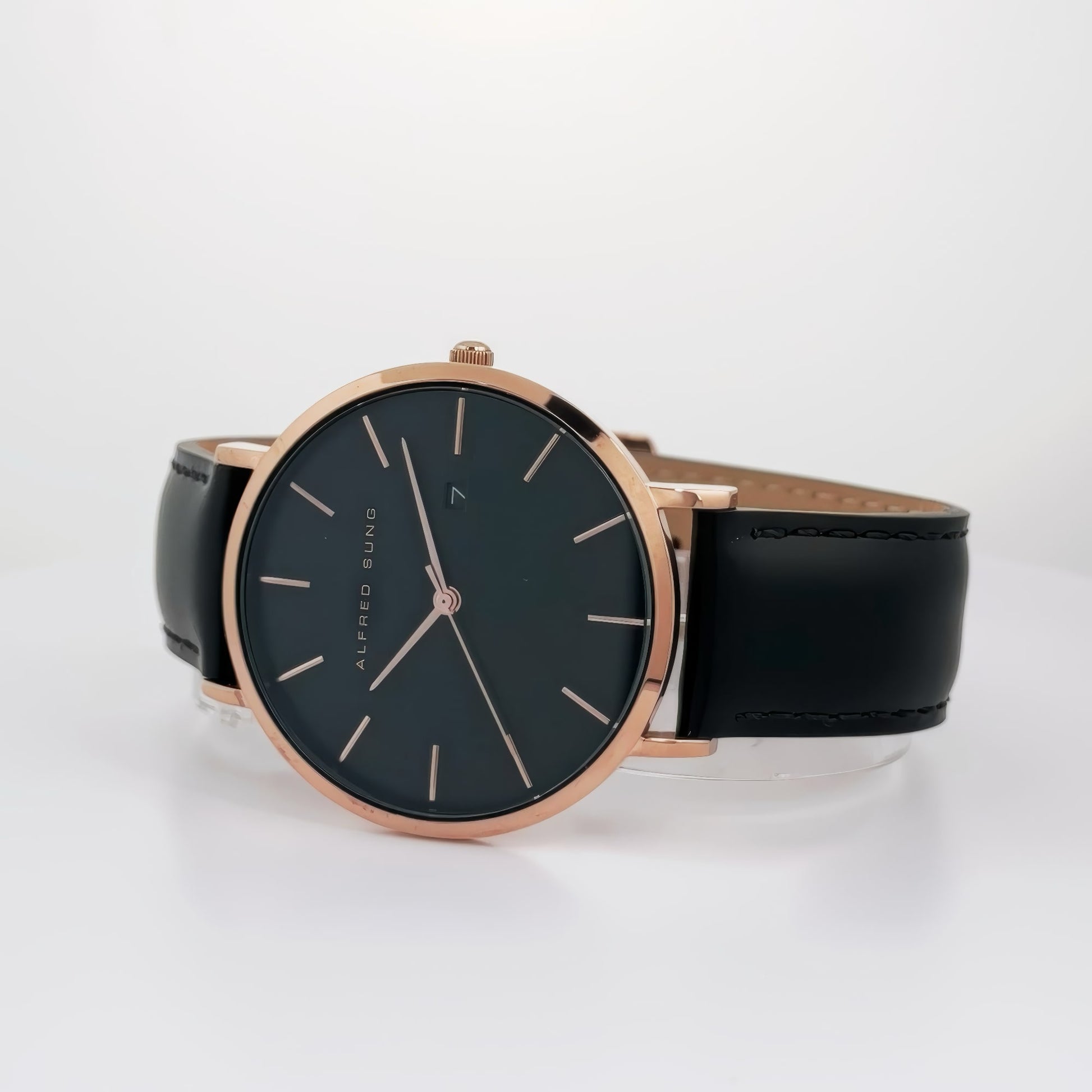 An elegant Alfred Sung Metropolitan wristwatch featuring a black dial and leather strap with simple indices.