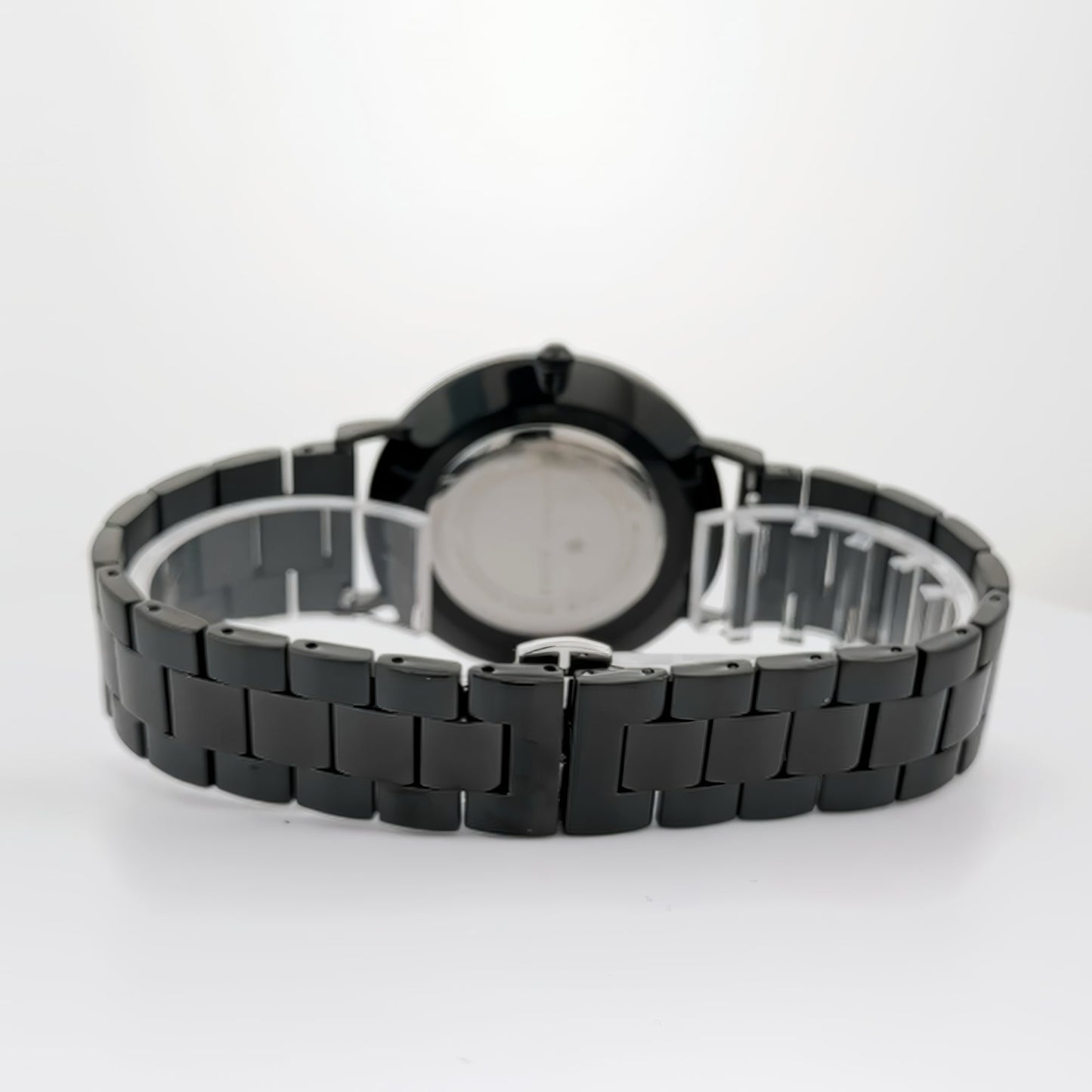 Alfred Sung Metropolitan Date watch with black dial and stainless steel bracelet against a white backdrop.