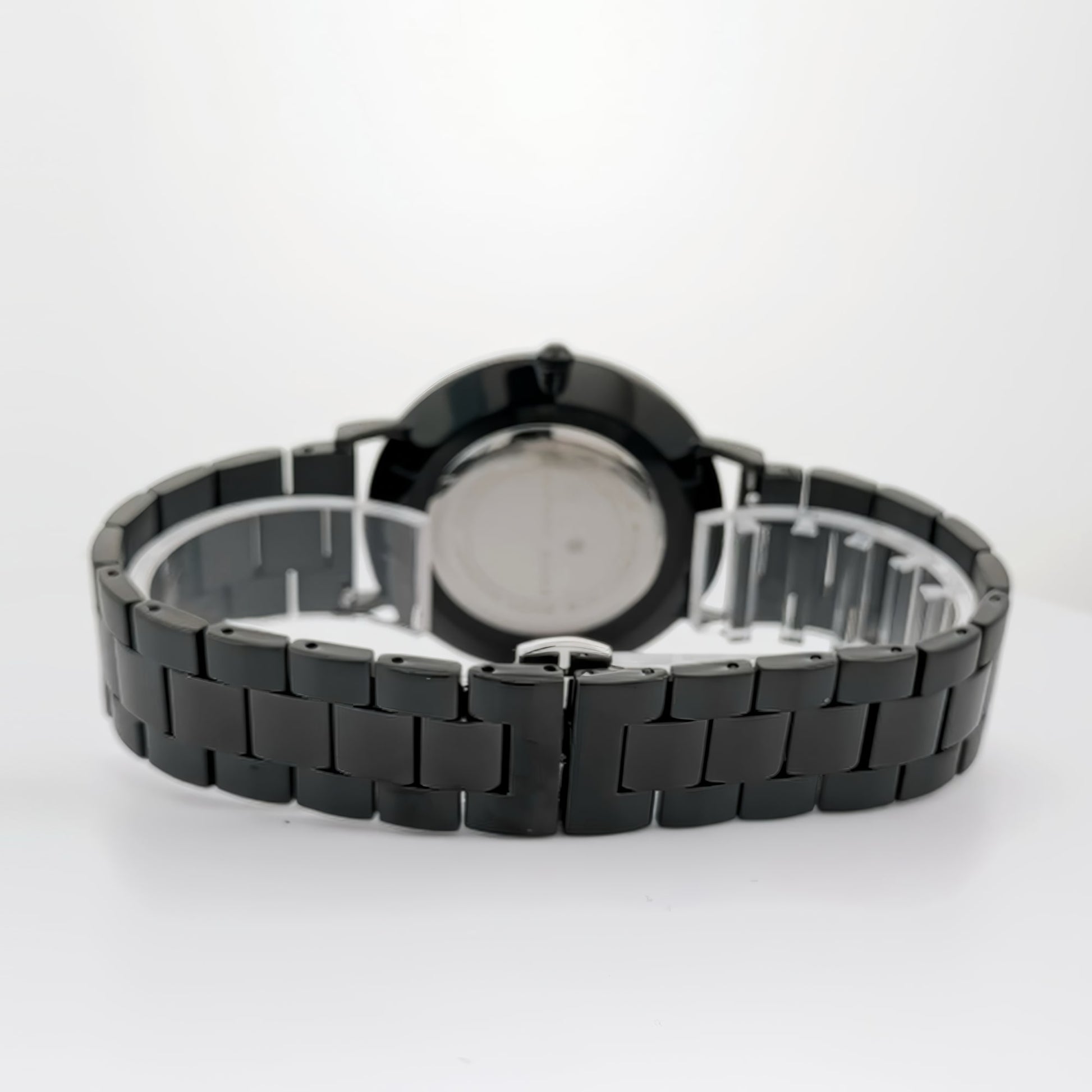 Alfred Sung Metropolitan Date watch with black dial and stainless steel bracelet against a white backdrop.