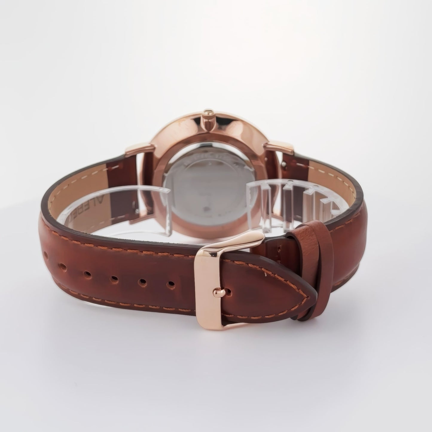 Back view of the Alfred Sung Metropolitan watch with a rosegold case, white dial, and brown leather strap.