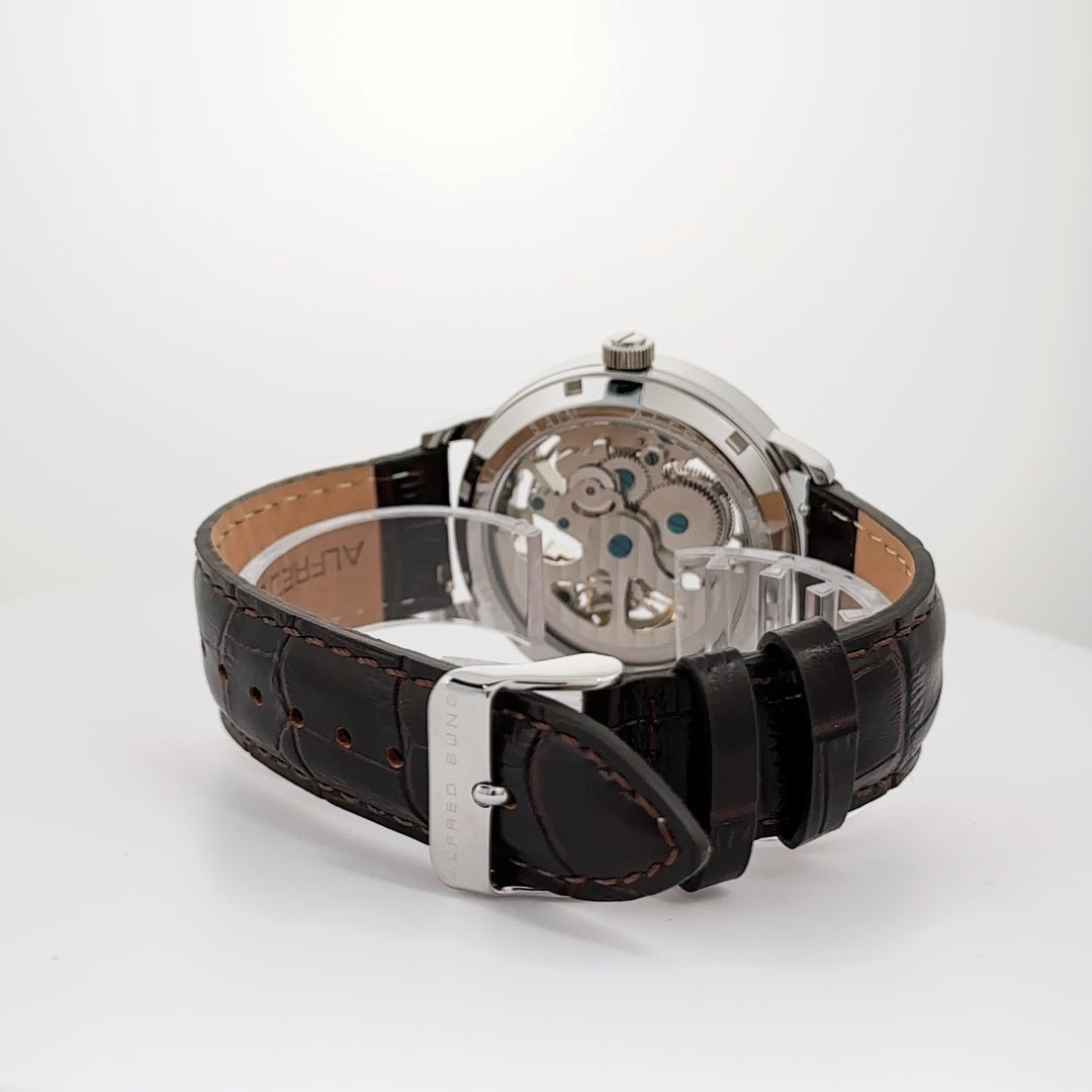 Alfred Sung Automatic III men’s watch with a white skeleton dial and brown leather strap, displayed on a white surface.
