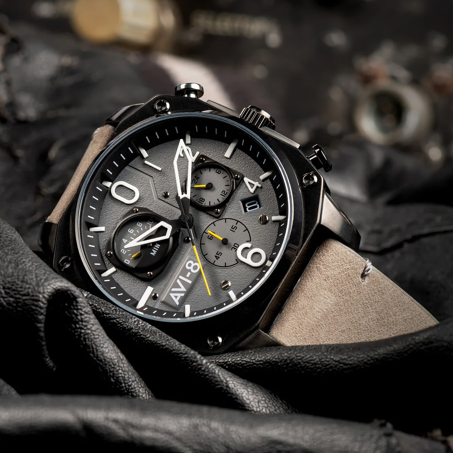 An AVI-8 Hawker Hunter watch with retrograde chronograph dials on a dark, textured surface in sea gray.