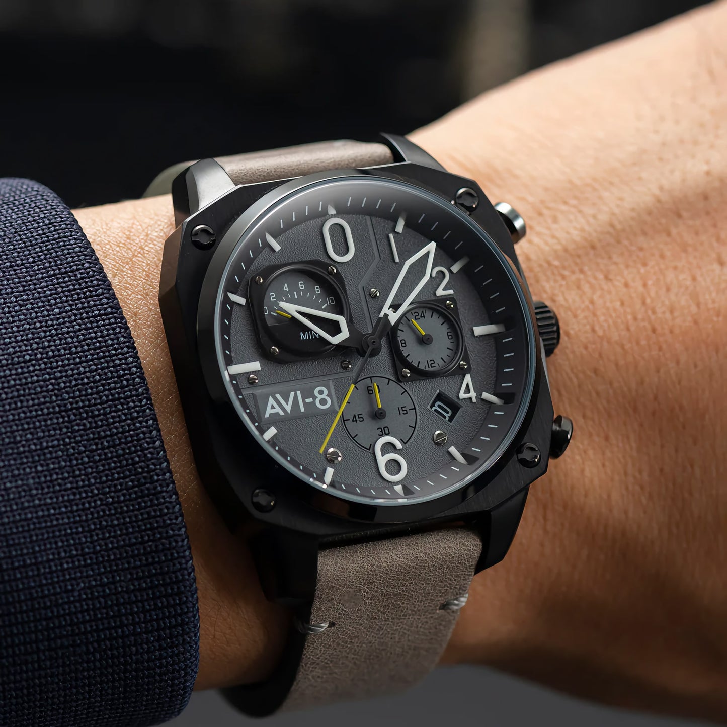 Person wearing an AVI-8 Sea Gray watch, inspired by Hawker Hunter heritage, featuring retrograde chronograph dials.