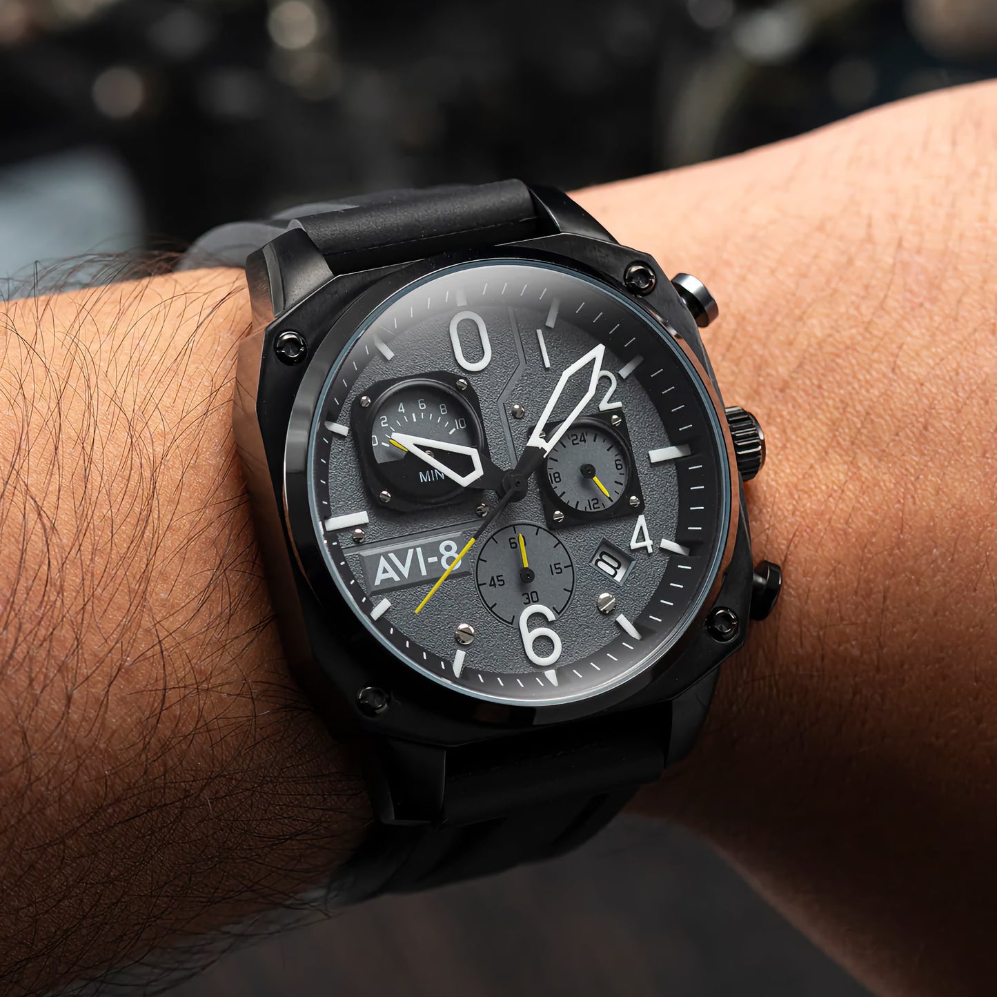 Close-up of someone wearing an AVI-8 Hawker Hunter Retrograde Chronograph in Tactical Black with a gray dial.