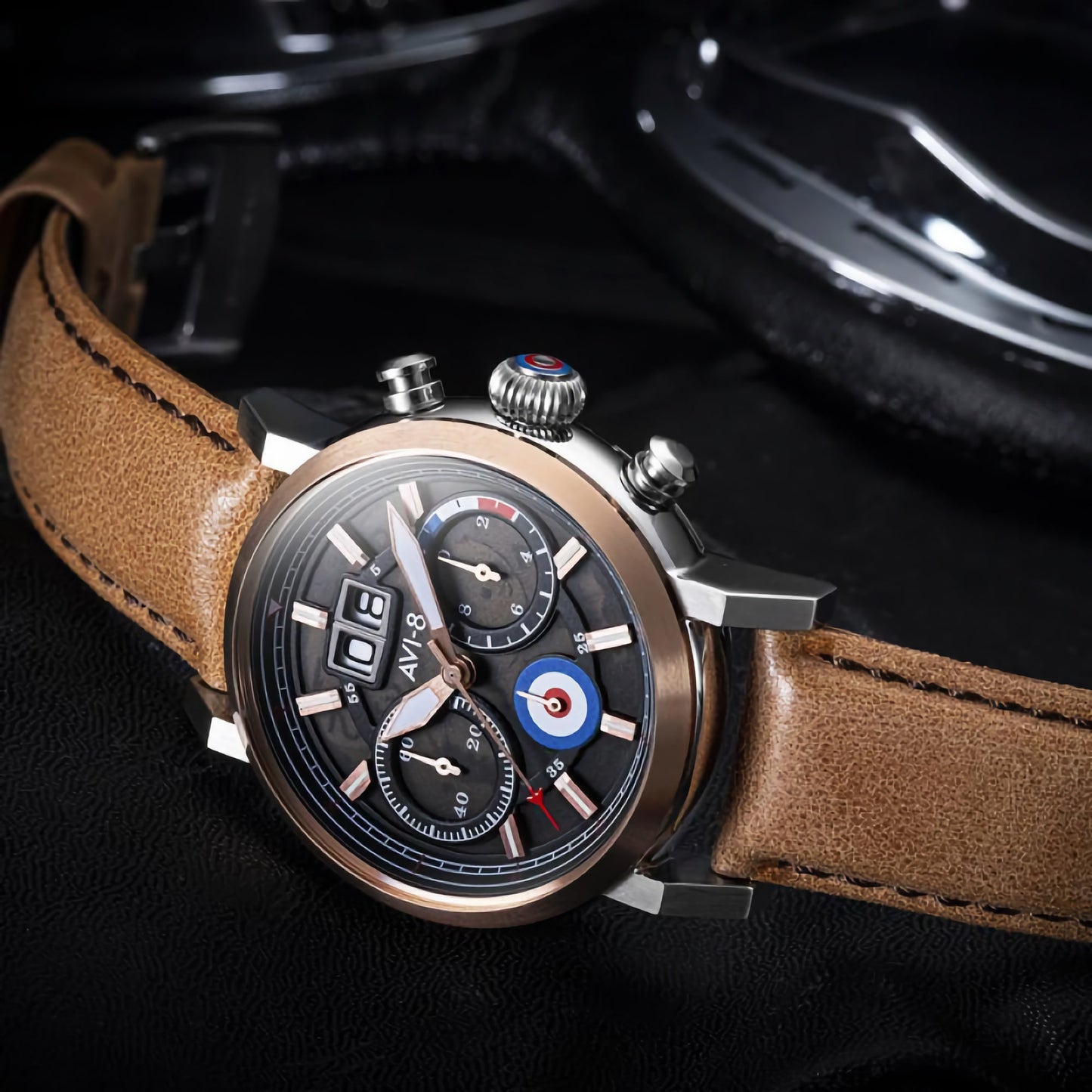 AVI-8 Hawker Hurricane Chronograph Men's watch with a brown leather strap, black dial, and silver case on a sleek surface.