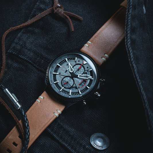 The AVI-8 Hawker Hunter Avon Chronograph rests on a jacket, highlighting its aviation heritage and intricate dial.