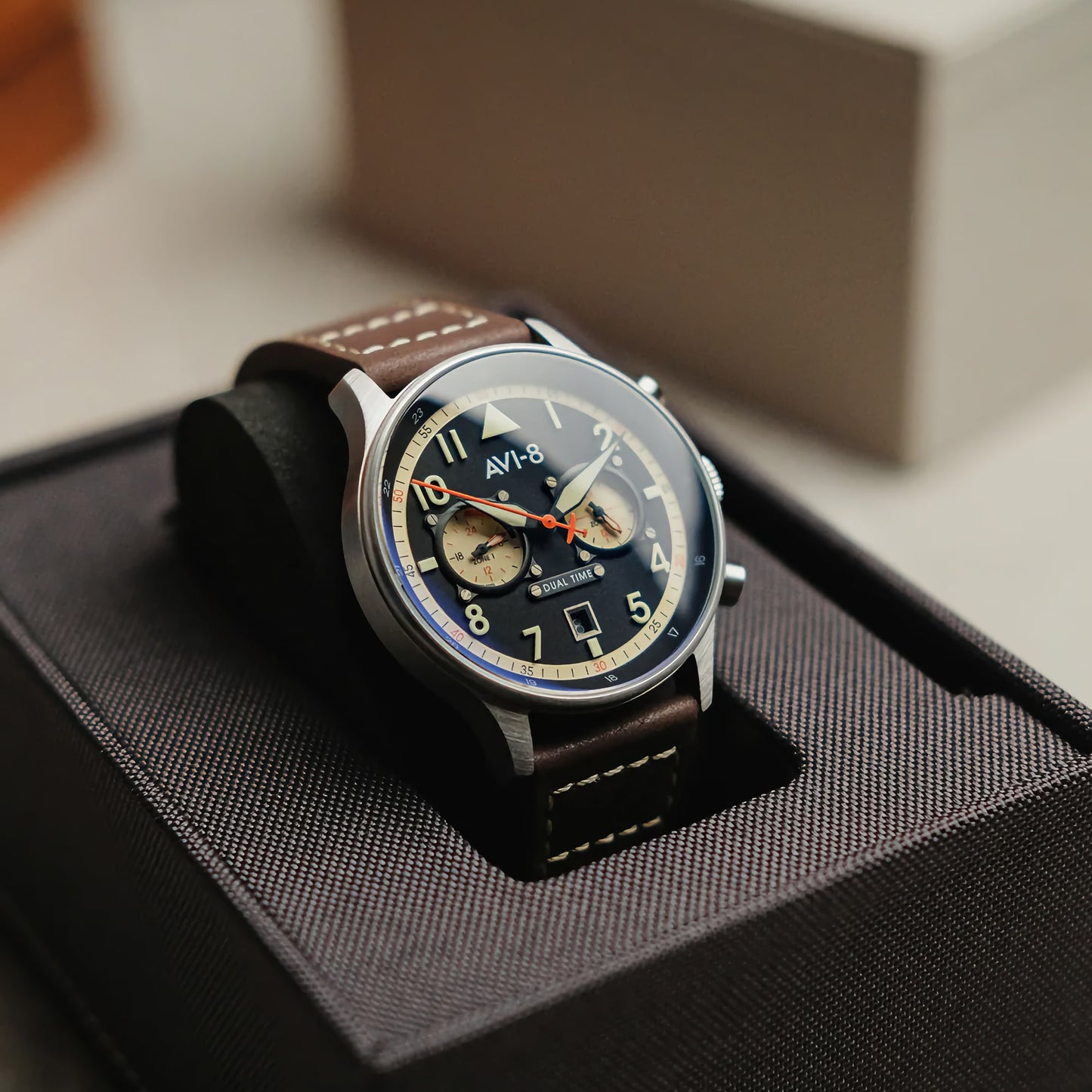 The AVI-8 Hawker Hurricane Carey Dual Time Manston has an aviation theme with a brown leather strap in a sleek black box.