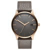 MVMT Classic Bronze Age Men's Watch features a gray dial, gold markers, and a gray leather strap.