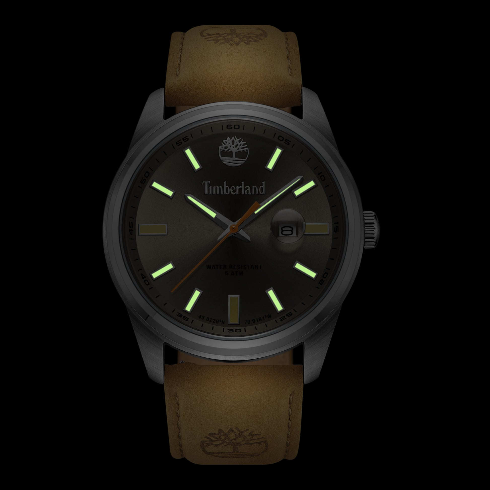 The Timberland Orford Men's watch features a brown leather strap and glowing green markers on a dark background.