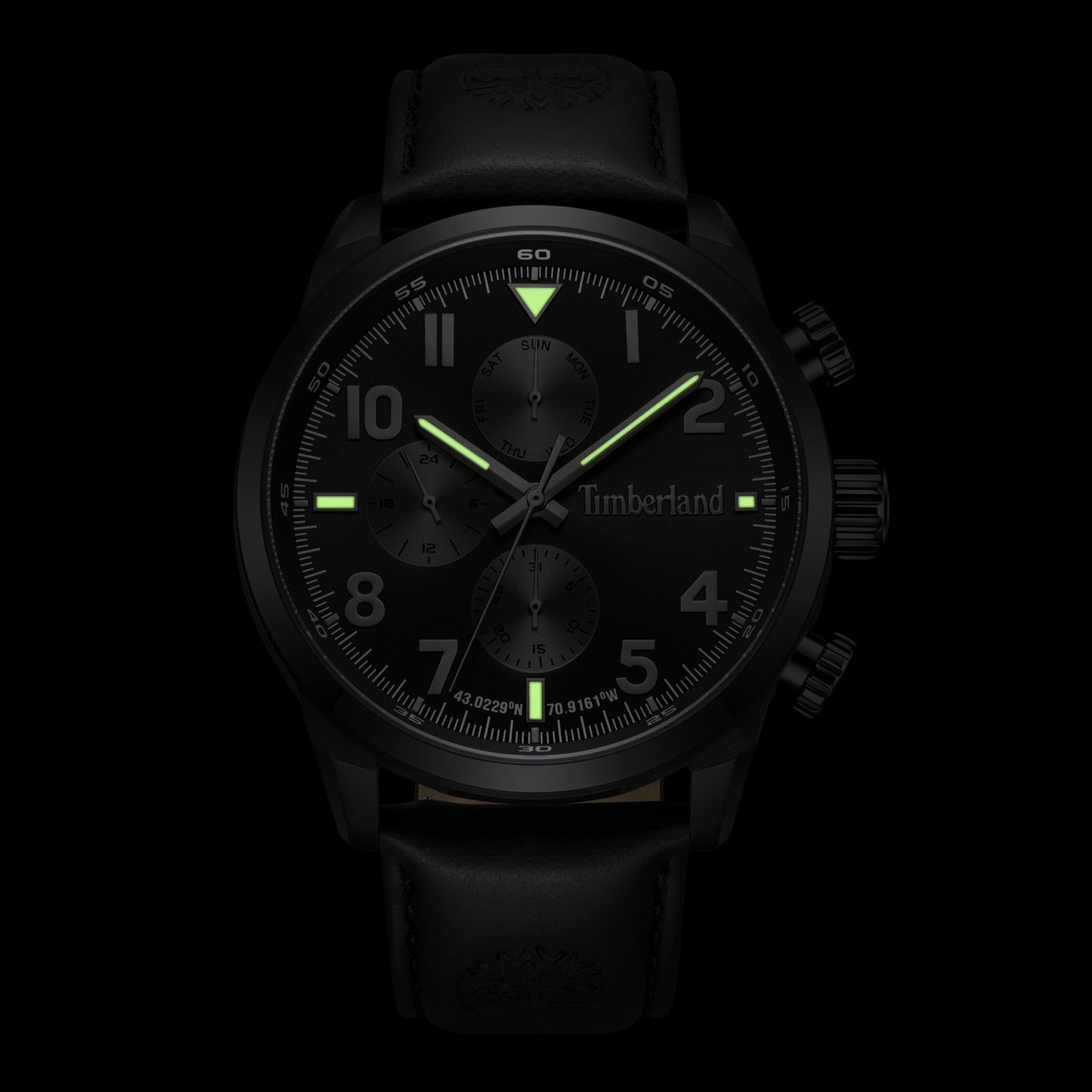 Timberland Henniker watch with glowing green hands and markers on a sunray navy dial.