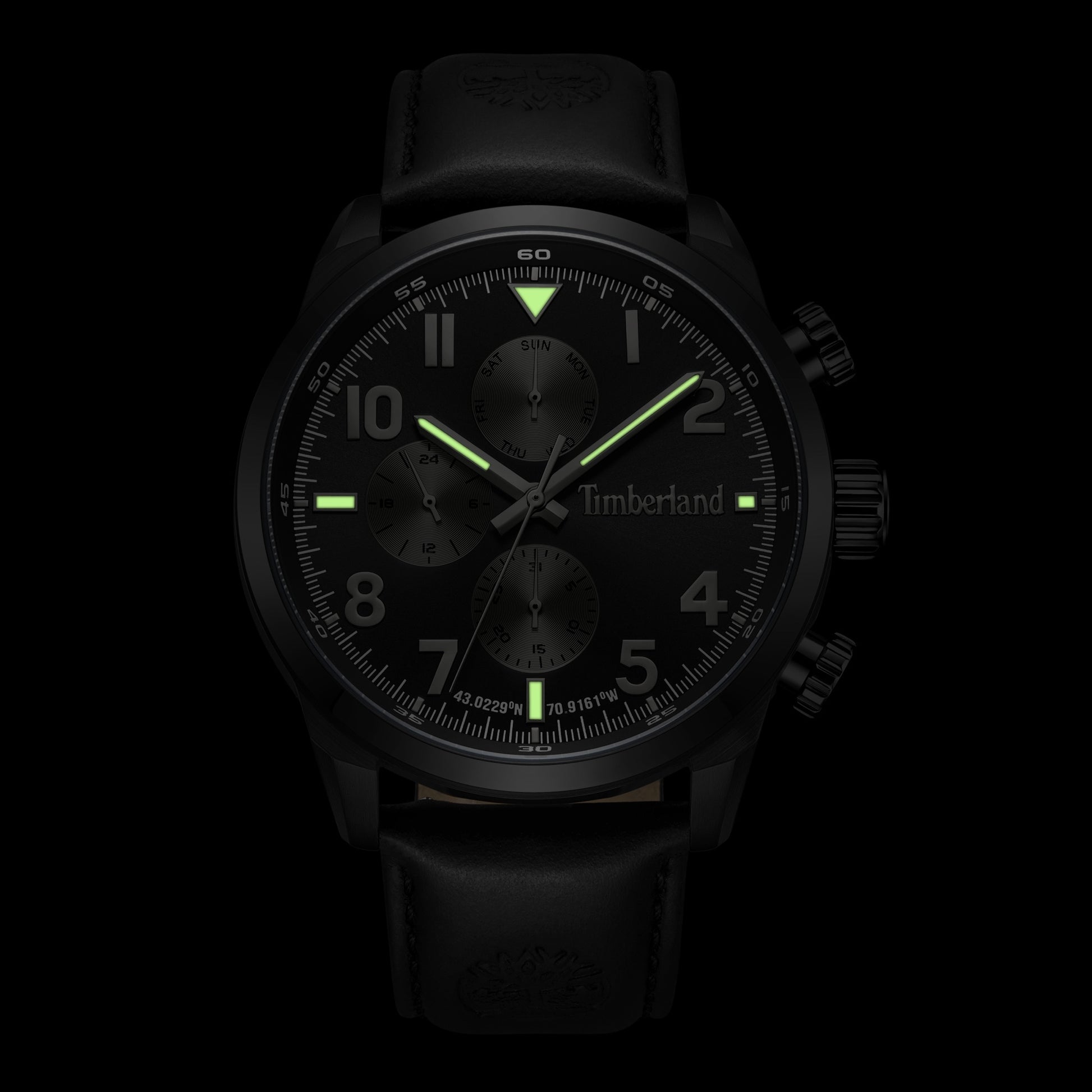 Timberland Henniker watch with glowing green hands and markers on a sunray navy dial.