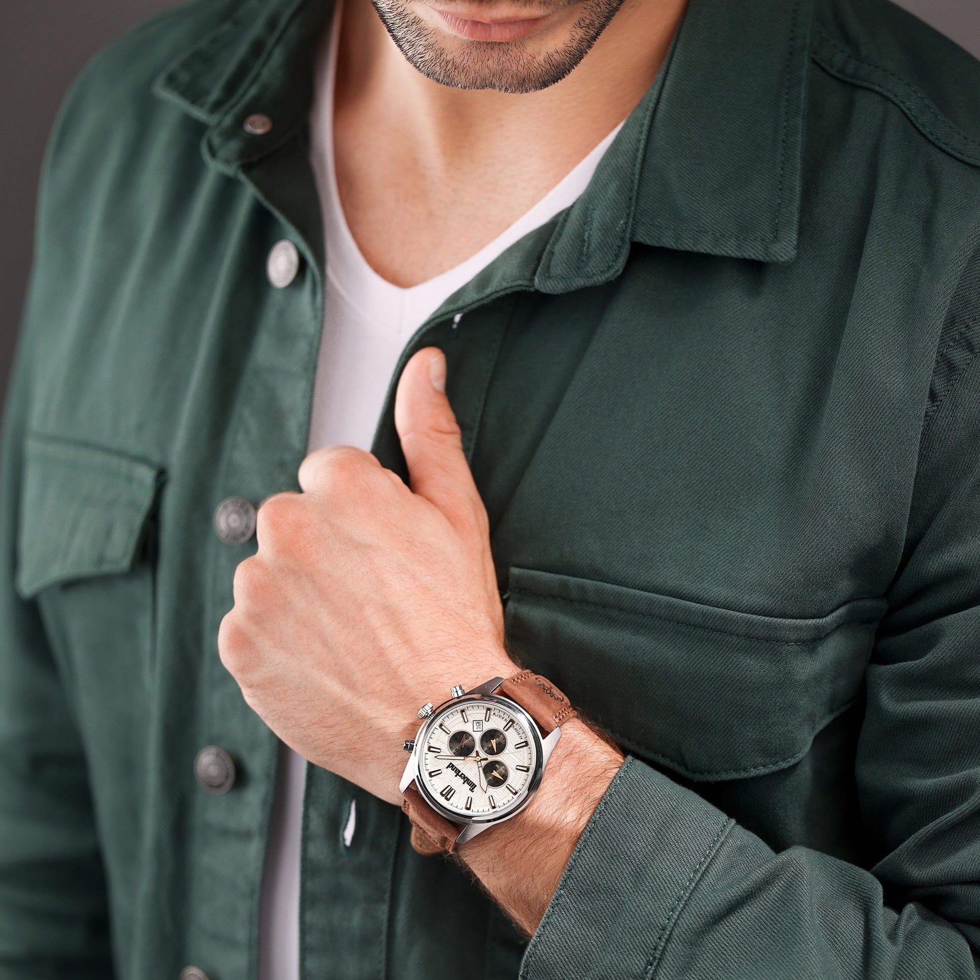 Person in a green jacket wearing a Timberland Northbridge Chronograph Watch gives a thumbs up.