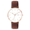 Alfred Sung Metropolitan watch with a rosegold case, white dial, and brown leather strap.