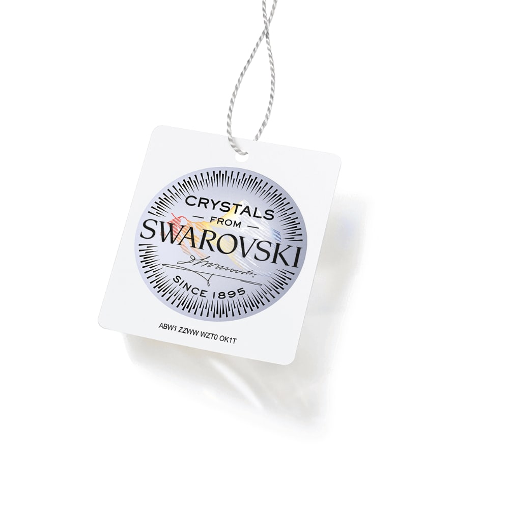 A hanging tag with "Crystals from Swarovski" logo, featuring a decorative circular design.