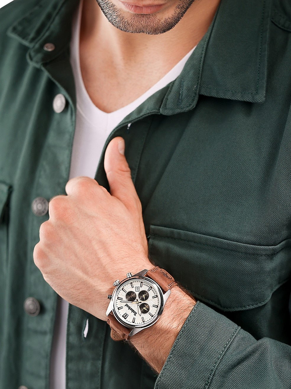 A man in a green shirt is wearing a Timberland Northbridge Stainless Steel & Leather Strap Chronograph Watch.
